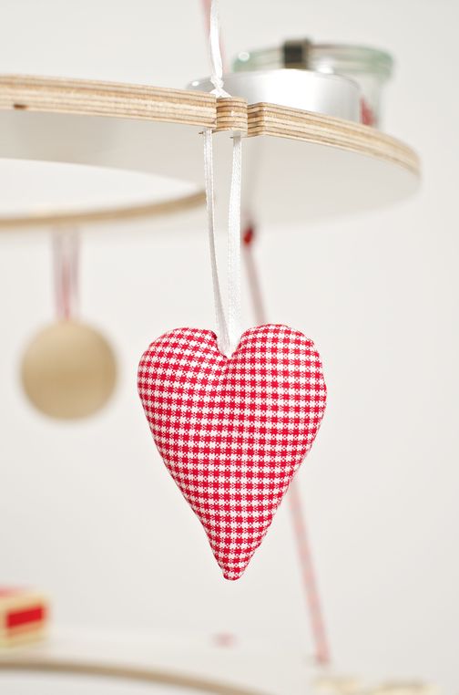 Heart of fabric hangs as a Christmas tree ornaments on the ecological Christmas tree
