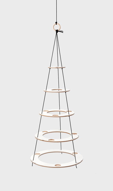 Small eco friendly Christmas tree made of wood in white with black ropes, which is reusable every year and can be individually decorated. A minimalist alternative to the traditional Christmas tree.