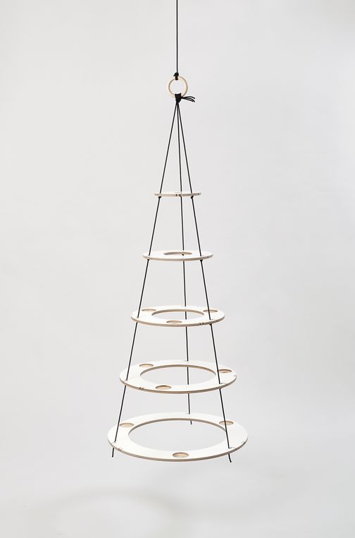 Small eco friendly Christmas tree made of wood in white with black ropes, which is reusable every year and can be individually decorated. A minimalist alternative to the traditional Christmas tree.