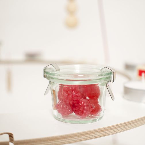 Red sweets in a jar as a festive ornament on the Scandinavian decorated Christmas tree Josef