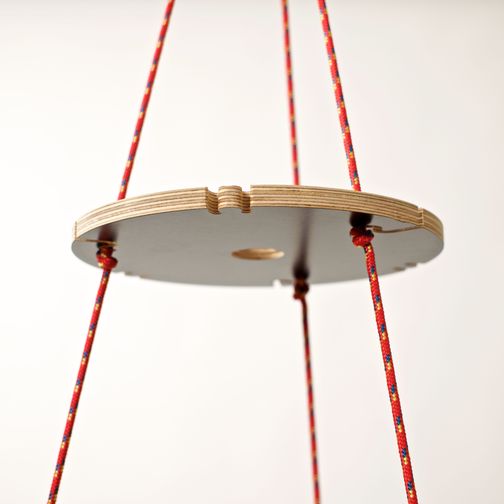 ecological christmas tree detail with plywood rings with black surface and red ropes